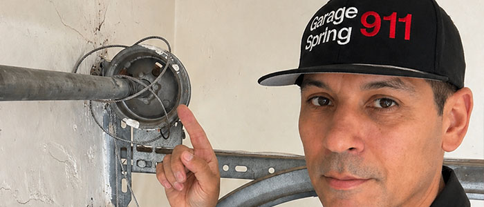 Garage door repair technician repacing a broken cable in San Diego CA.